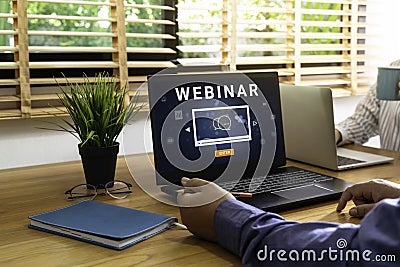 Person using a laptop computer for online training webinars. E-learning browsing connection and cloud online technology webcast Stock Photo