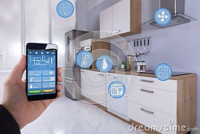 Person Using Smart Home Application On Smartphone Stock Photo