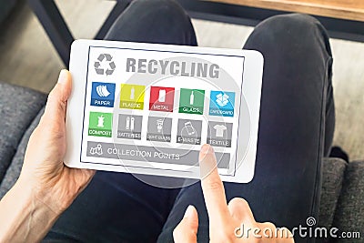 Person using tablet website for sorting recyclable waste material, recycling Stock Photo