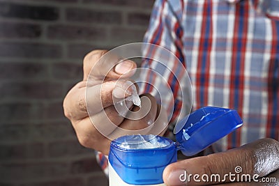 Person using white petroleum jelly, close up Stock Photo