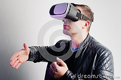 A person in VR glasses shakes hands, the concept of communication in virtual reality, Dating in cyberspace Stock Photo