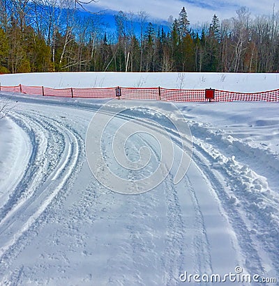 Snowmobile trail in secluded area with curve Stock Photo