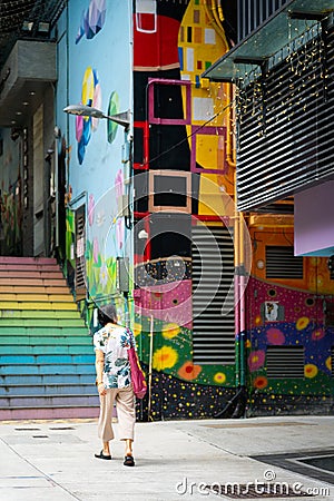 Person walking up the colorful stairs in Hong Kong Editorial Stock Photo