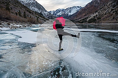 A person walks across a frozen lake Stock Photo