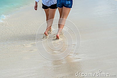 Person walks along a paradisiacal Caribbean beach Stock Photo