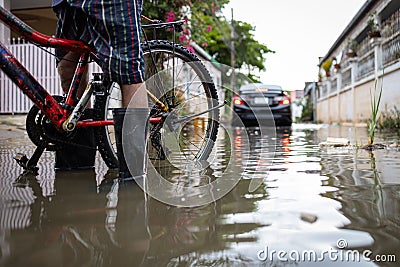 Person wear rubber boots,prevent infection of leptospirosis,athlete`s foot,disease from dirty water,male in waterproof boots in a Stock Photo