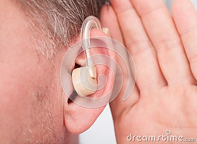Person wearing hearing aid Stock Photo