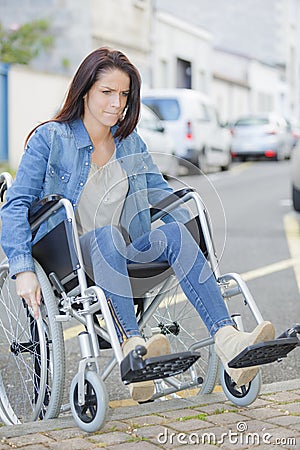 Person in wheelchair faces difficulties with transportation Stock Photo