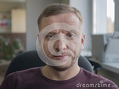 Person whose eyes are lopsided. Man with gray eyes and a beard. Midlife person with wrinkles on the forehead Stock Photo