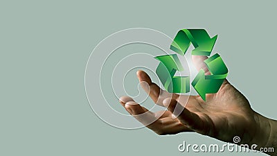 Person's hand holding a 3D rendered green recycling symbol Stock Photo