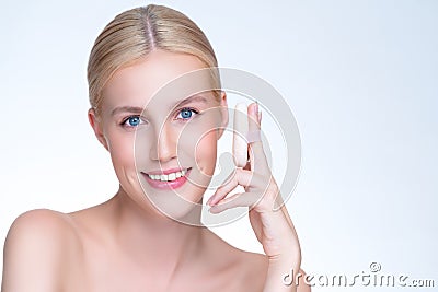 Personable beautiful natural makeup woman using powder puff for facial makeup. Stock Photo