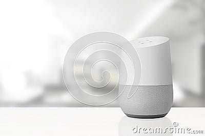 Personal assistant loudspeaker on a white wooden shelf of a smart home living room. Next, a book. Empty copy space Stock Photo