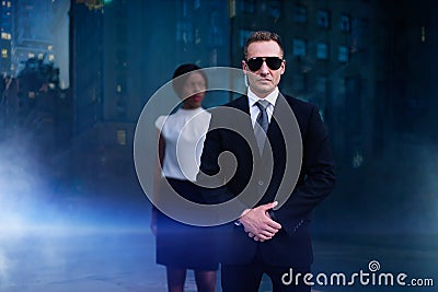 Personal bodyguard of black business woman Stock Photo