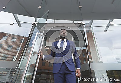 Personal bodyguard monitoring environment before boss will leave the building Stock Photo