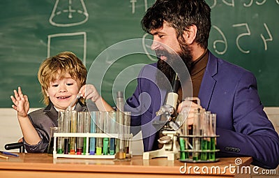 Personal example. Knowledge day. Chemical experiment. Study chemistry together. Following father in everything. My Stock Photo