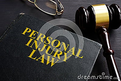 Personal Injury Law book and a black desk Stock Photo