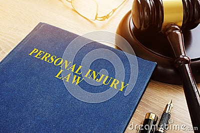 Personal injury law on a desk and gavel. Stock Photo