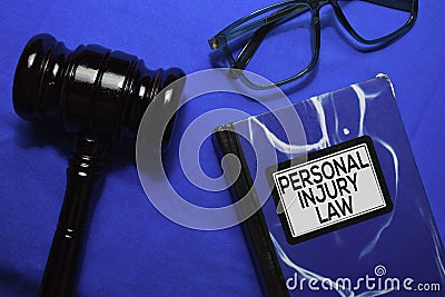 Personal Injury Law text on Book and gavel isolated on office desk. Stock Photo