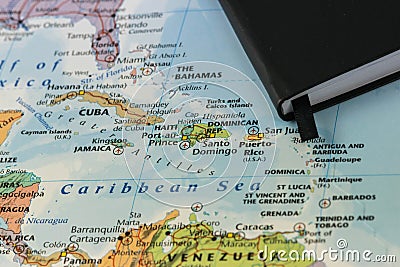 Personal notes of someone planning a trip to the caribbean sea over a closeup map of Cuba, Haiti, Jamaica, Dominican Stock Photo