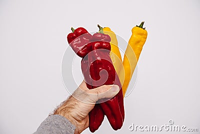 Personal perspective male hand-holding in hands four delicious long peppers two Stock Photo