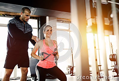 Personal trainer assisting woman lose weight Stock Photo