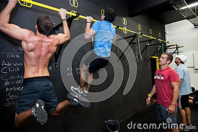 Personal Trainer giving fitness instruction at a Crossfit group class Editorial Stock Photo