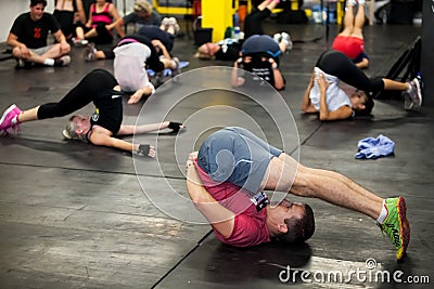 Personal Trainer giving fitness instruction at a Crossfit group class Editorial Stock Photo