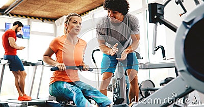 Personal trainer giving instructions in gym Stock Photo