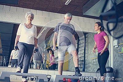 Personal trainer working exercise with senior couple. Stock Photo