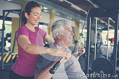 Personal trainer working exercise with senior man. Stock Photo