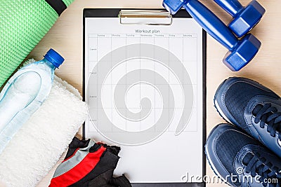 Personal workout plan with sneakers and dumbbells Stock Photo