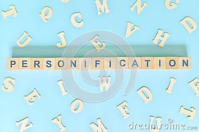 Personification figure of speech concept in English grammar class lesson. Wooden blocks typography flat lay in blue background. Stock Photo