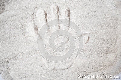 A persons handprint on the sand top view Stock Photo