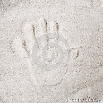 A persons handprint on the sand top view Stock Photo