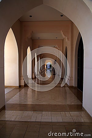 Perspective of the arcade with arches, columns and decorated floor, Muscat, Oman Stock Photo