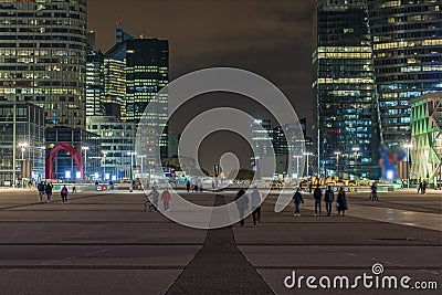 France, Paris Perspective Game at La Defense District With Peoples and Towers at Night Editorial Stock Photo