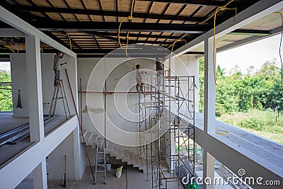Perspective inside of house under construction with workers Editorial Stock Photo