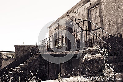 Perspective of old typical house with balcony, flower pots and stairs, Portugal Stock Photo