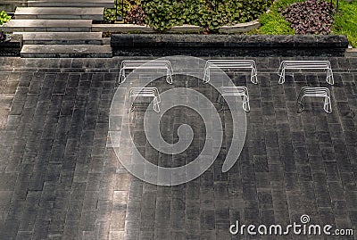 Perspective outdoor white metal benchs in open empty space area of the park Stock Photo