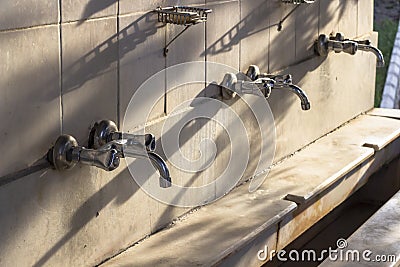 Perspective shoot of water taps in the mosque at sunset time Stock Photo