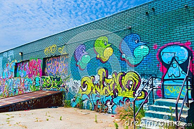 Perspective shot of colorful contemporary graffiti on the side of a loading dock in downtown Los Angeles Editorial Stock Photo