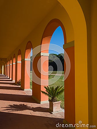 Perspective view of an arched walkway in a sunny day Stock Photo