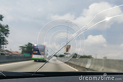 Perspective view of cracked car windscreen or windshield while d Stock Photo