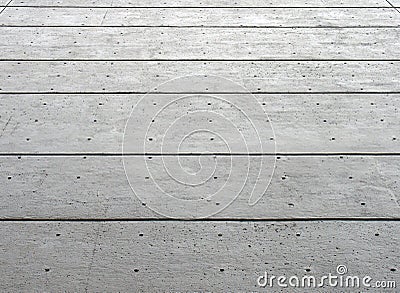 Perspective view of a large grey textured concrete wall with black horizontal lines and a pattern of repeating dots Stock Photo