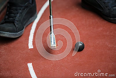 Perspective view from a minigolf player with a iron racket and a Stock Photo