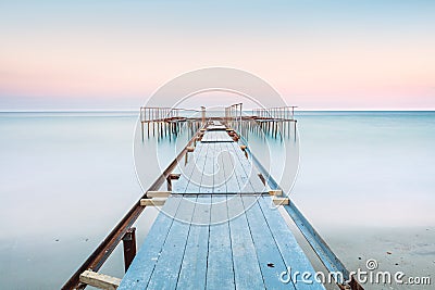 Long esposure view of a old jetty in a calm sea with gentle sky, soft colors Stock Photo