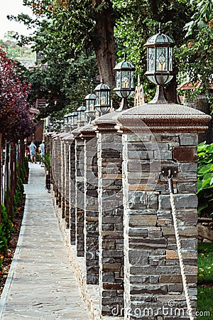 Perspective view of retro lanterns on pillars stacked of bricks Stock Photo