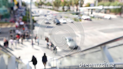 Perspective view thru escalator, defocused unrecognizable group of people on road intersection crosswalk on Strip of Las Vegas, Stock Photo