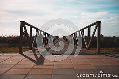 Perspective View of a Wooden Bridge Constructed on Brick Pavements Stock Photo