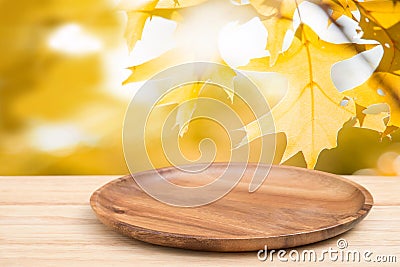 Perspective wooden table on top over blur natural of maple leaf Stock Photo